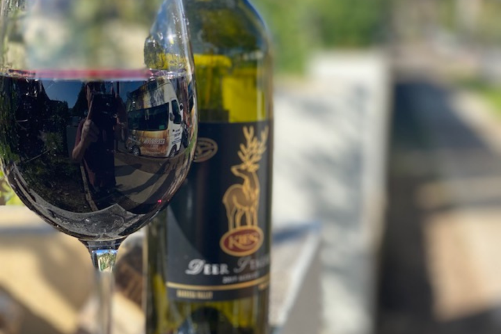 Close up of a bottle and a glass of red wine