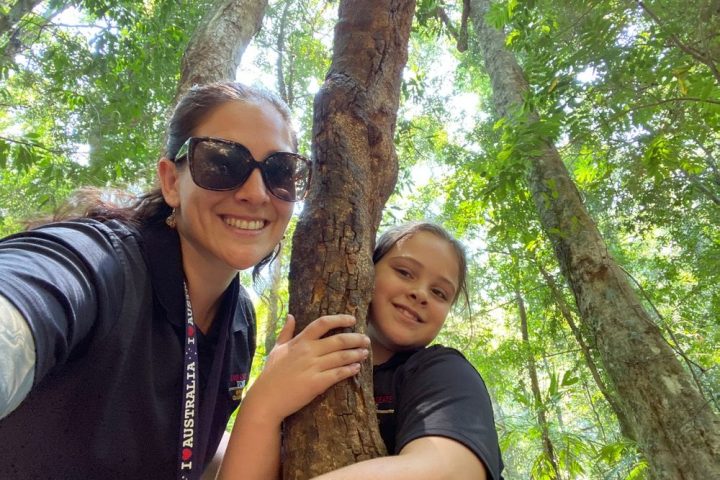 a man and a woman taking a selfie in a forest