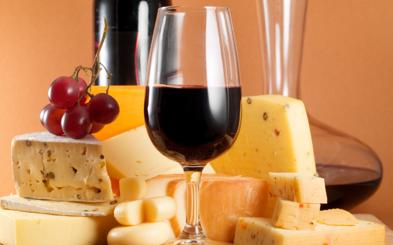 a glass of wine sitting on top of a wooden table