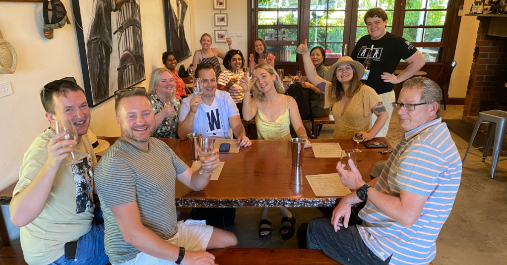 a group of people sitting at a table with wine glasses