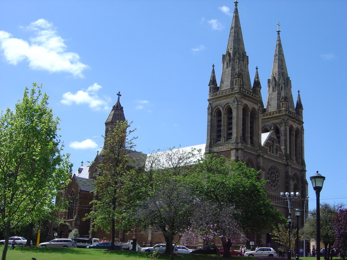 a church with a large clock tower in the background