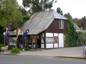 a house that has a sign on the side of a road