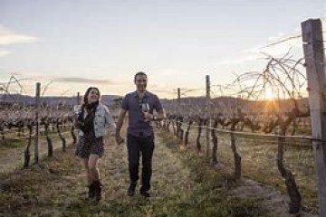 a man standing next to a fence