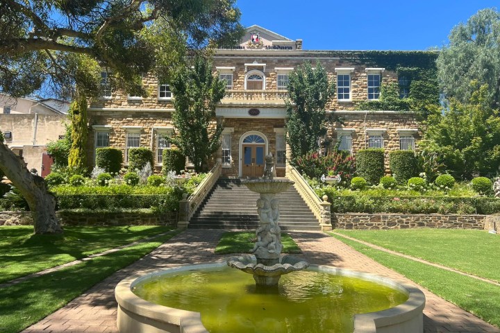 a small clock tower in the middle of a park