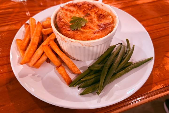 Plate with casserole, fries, and green beans.