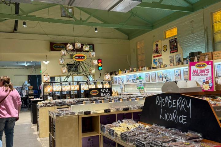 Interior of a candy shop with licorice display and bright overhead lights.