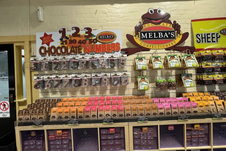 Shelves with chocolate numbers and packaged candies at Melba's Confectionery store display.