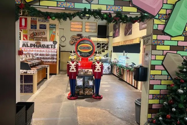 Candy store entrance with toy soldiers and various confectionery displays.